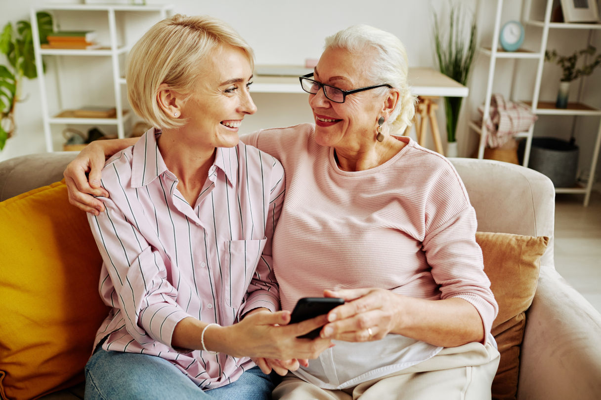 elderly senior with caregiver on sofa